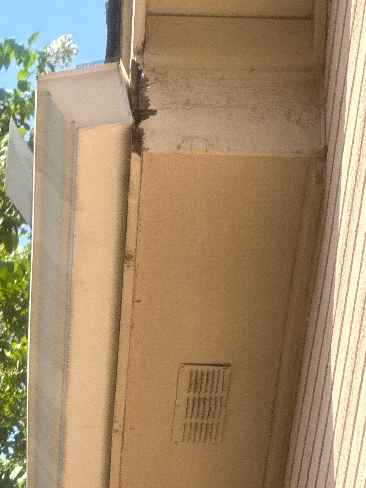 Wood corner repair with Bondo on right side of house ahead of exterior painting