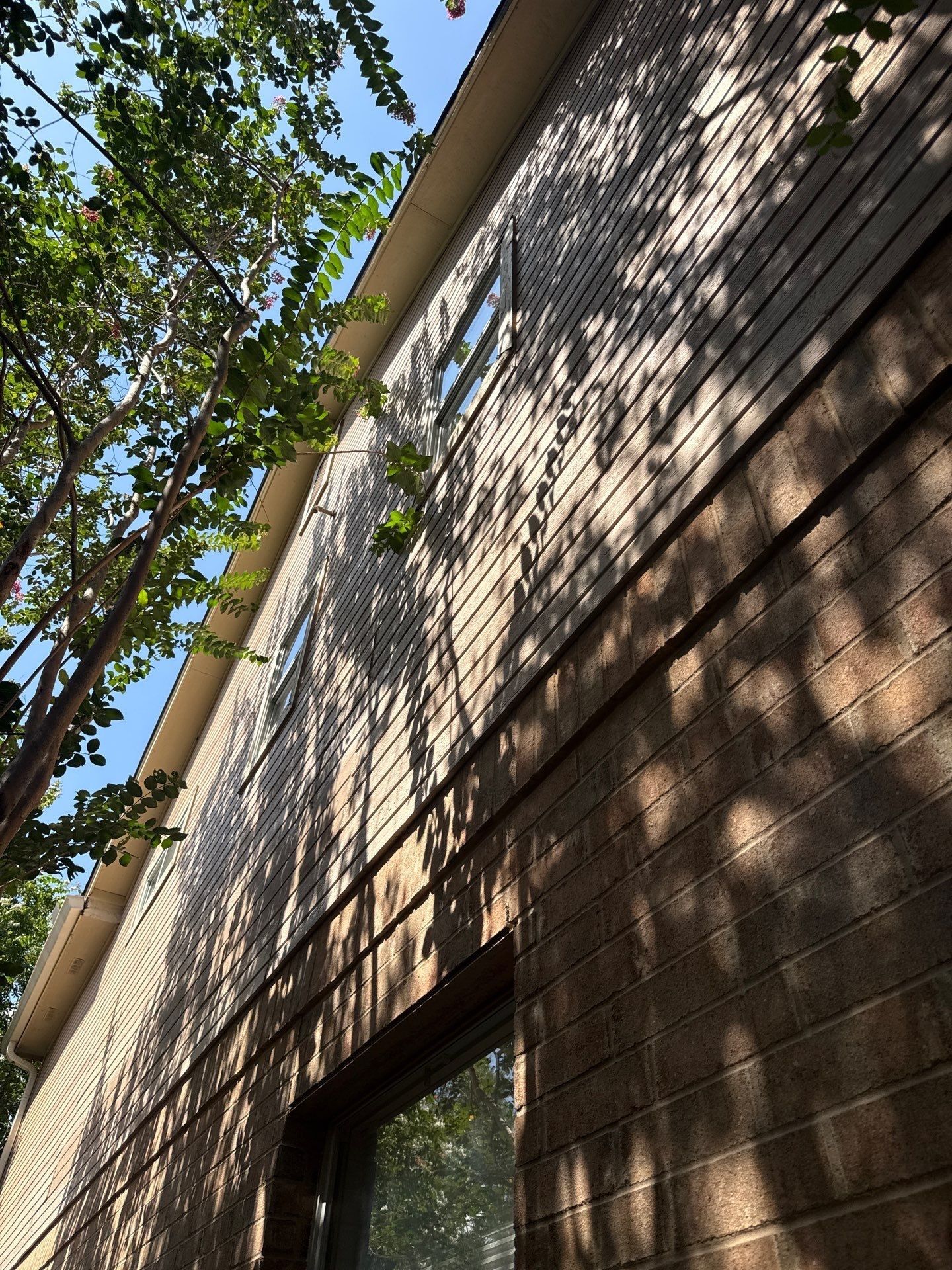 Window trim area on right side of house ahead of replacement and painting