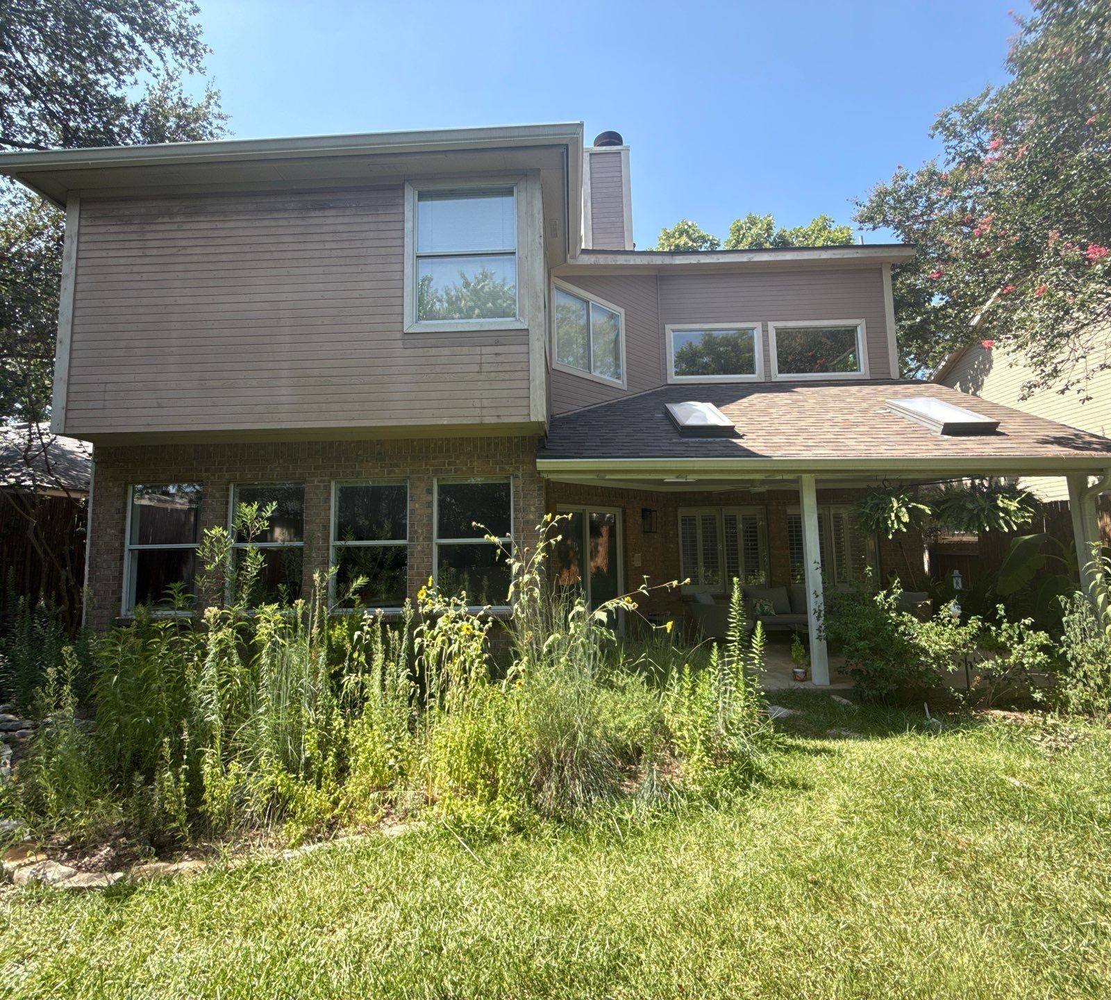 Back exterior of house with covered porch ahead of painting