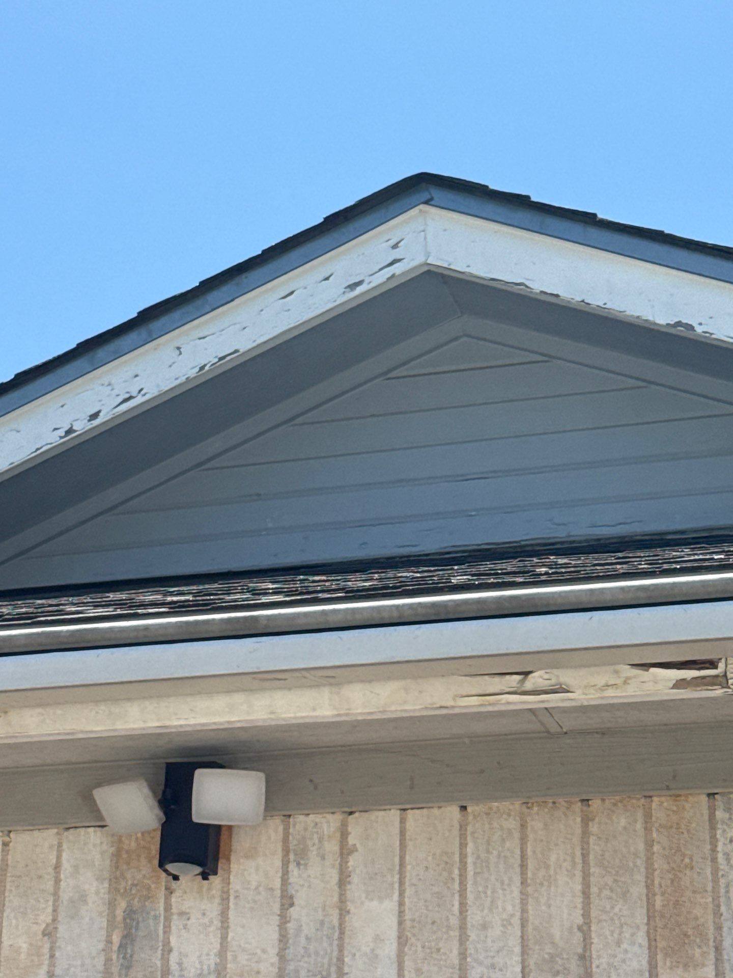 Gable end prepared for scraping, power washing, and painting