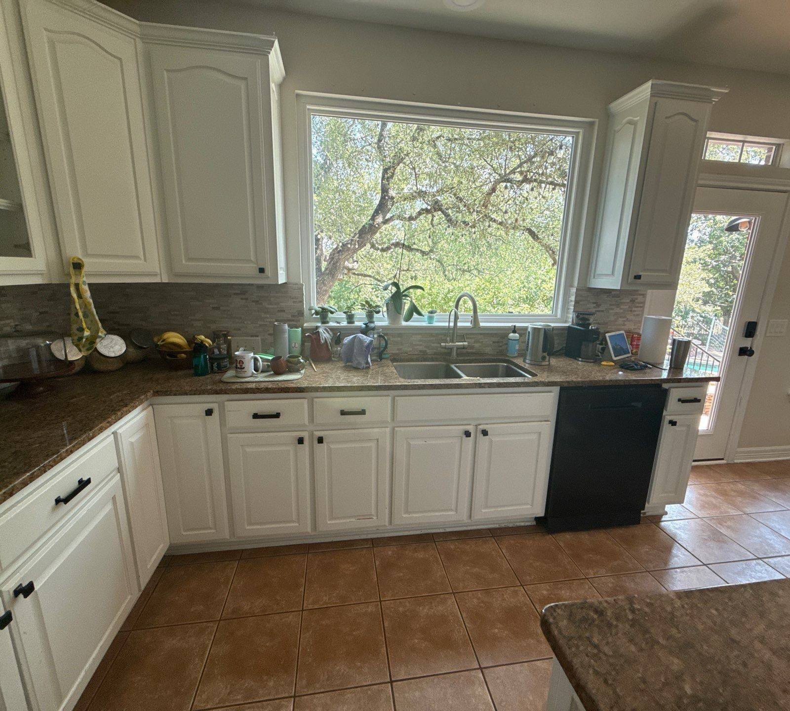 Kitchen sink and counter area ahead of cabinet refinishing