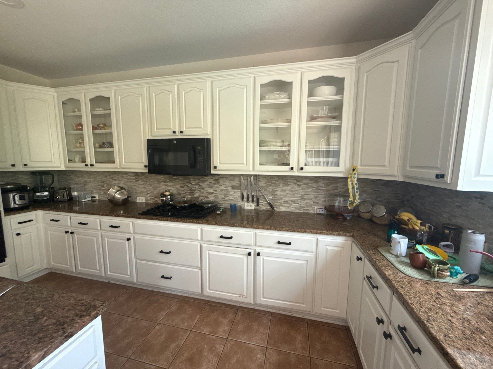 Wide view of kitchen cabinets ahead of refinishing