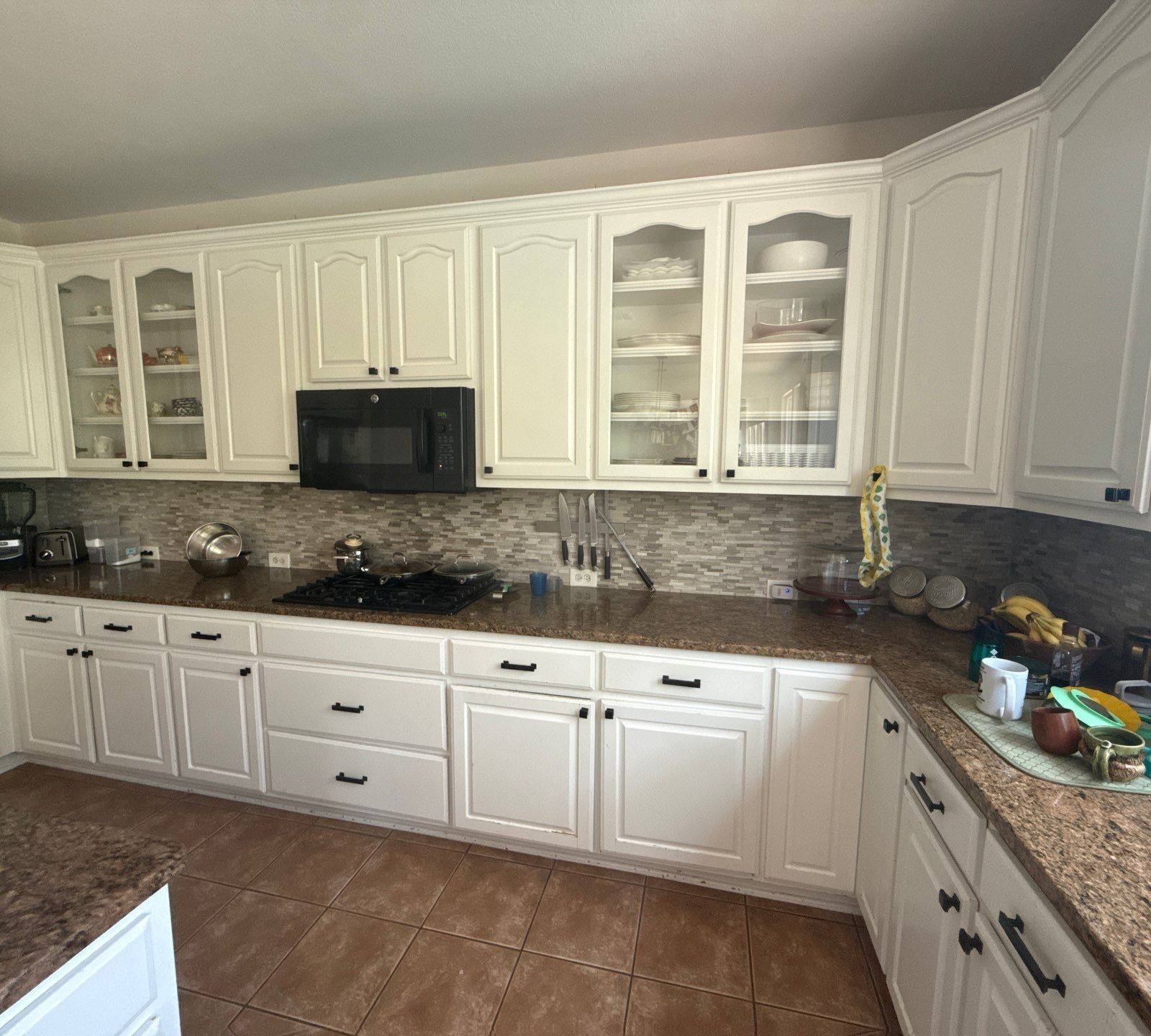 Wide view of kitchen cabinets ahead of refinishing