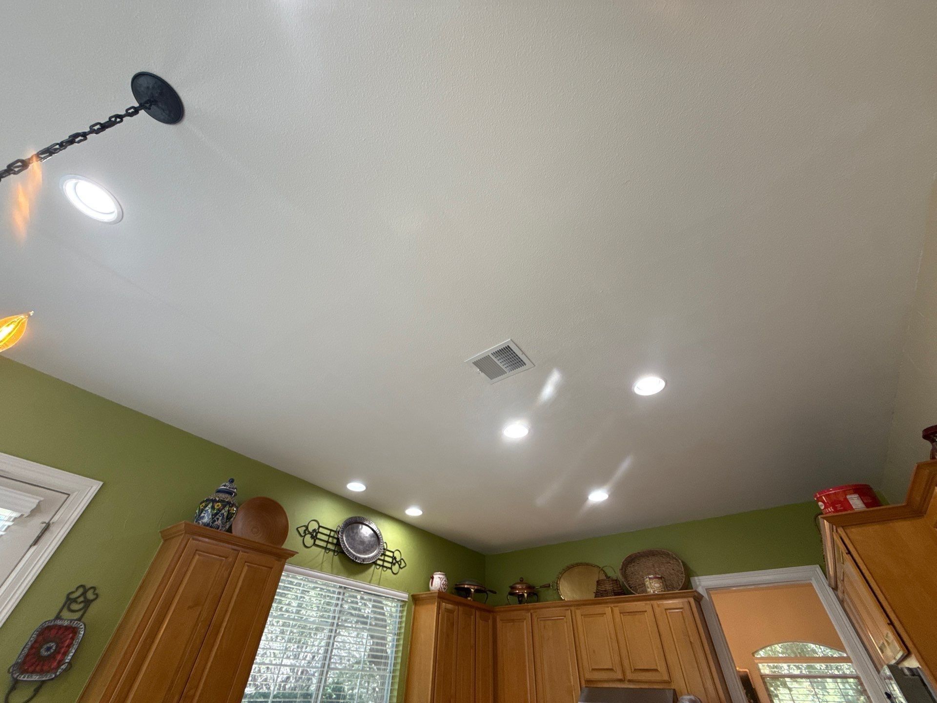 Kitchen ceiling and green walls ahead of painting