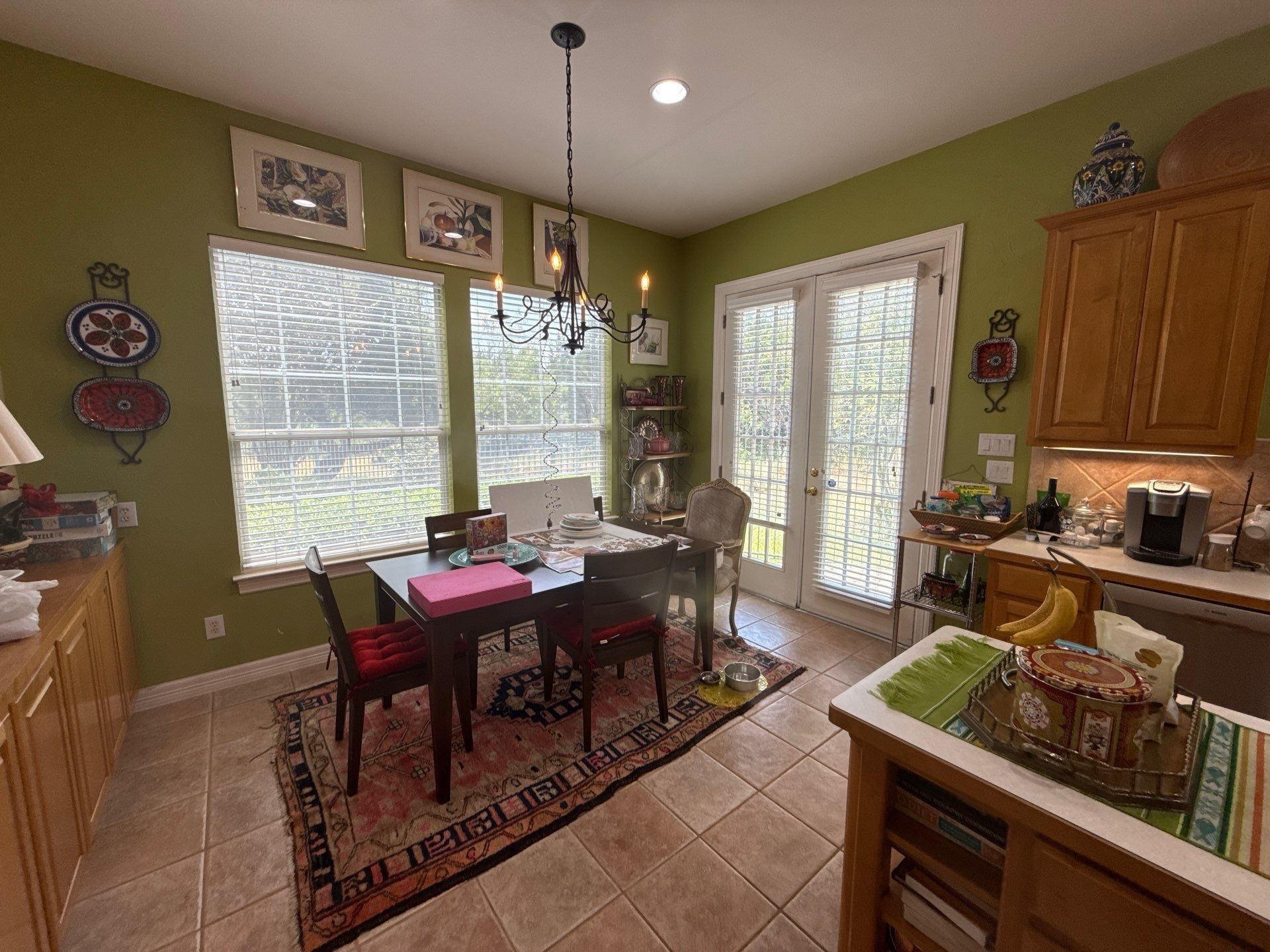 Kitchen dining nook with green walls ahead of painting