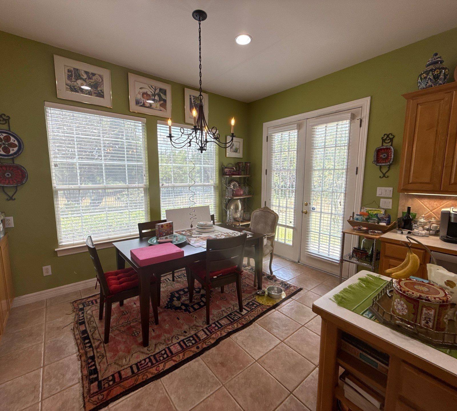Kitchen dining nook with green walls ahead of painting