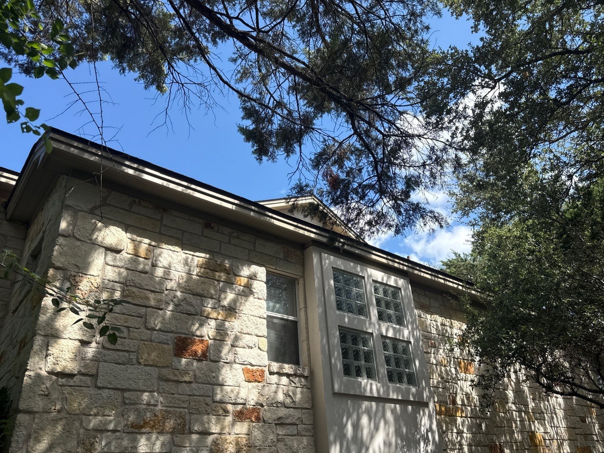 Side exterior with stone wall and glass block window