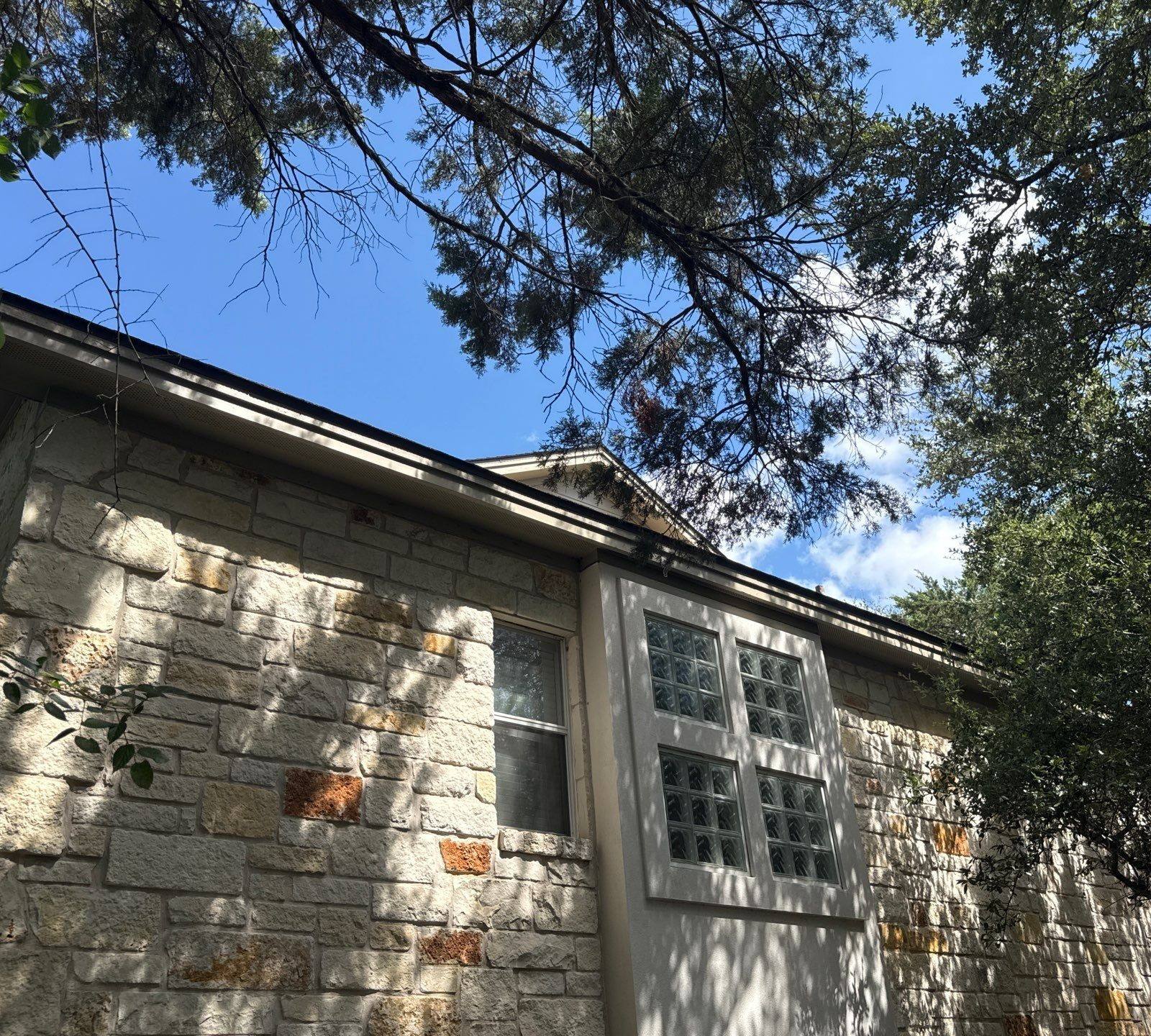 Side exterior with stone wall and glass block window