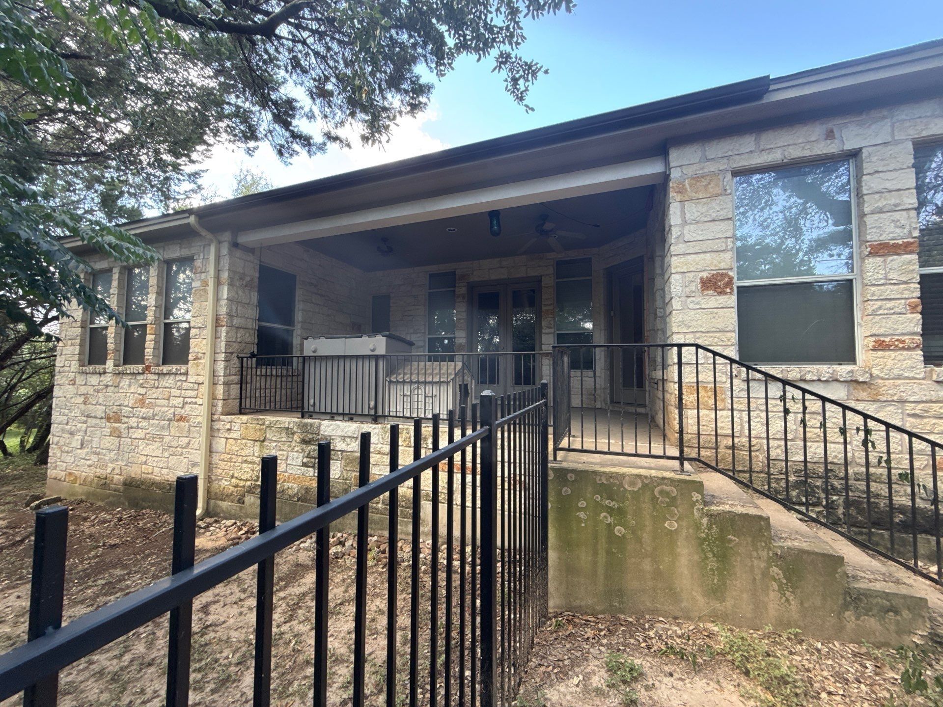 Back porch entry with railing and steps