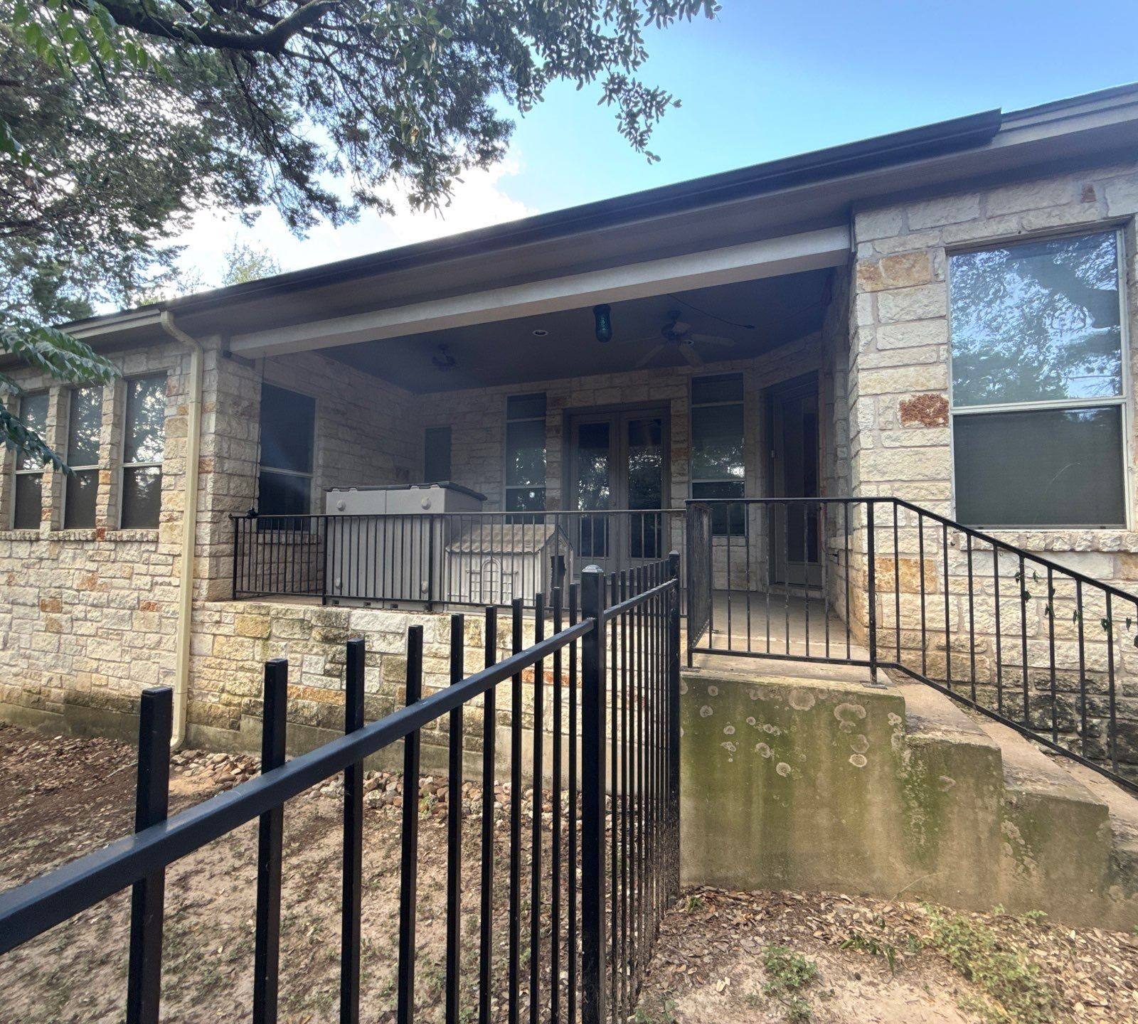Back porch entry with railing and steps