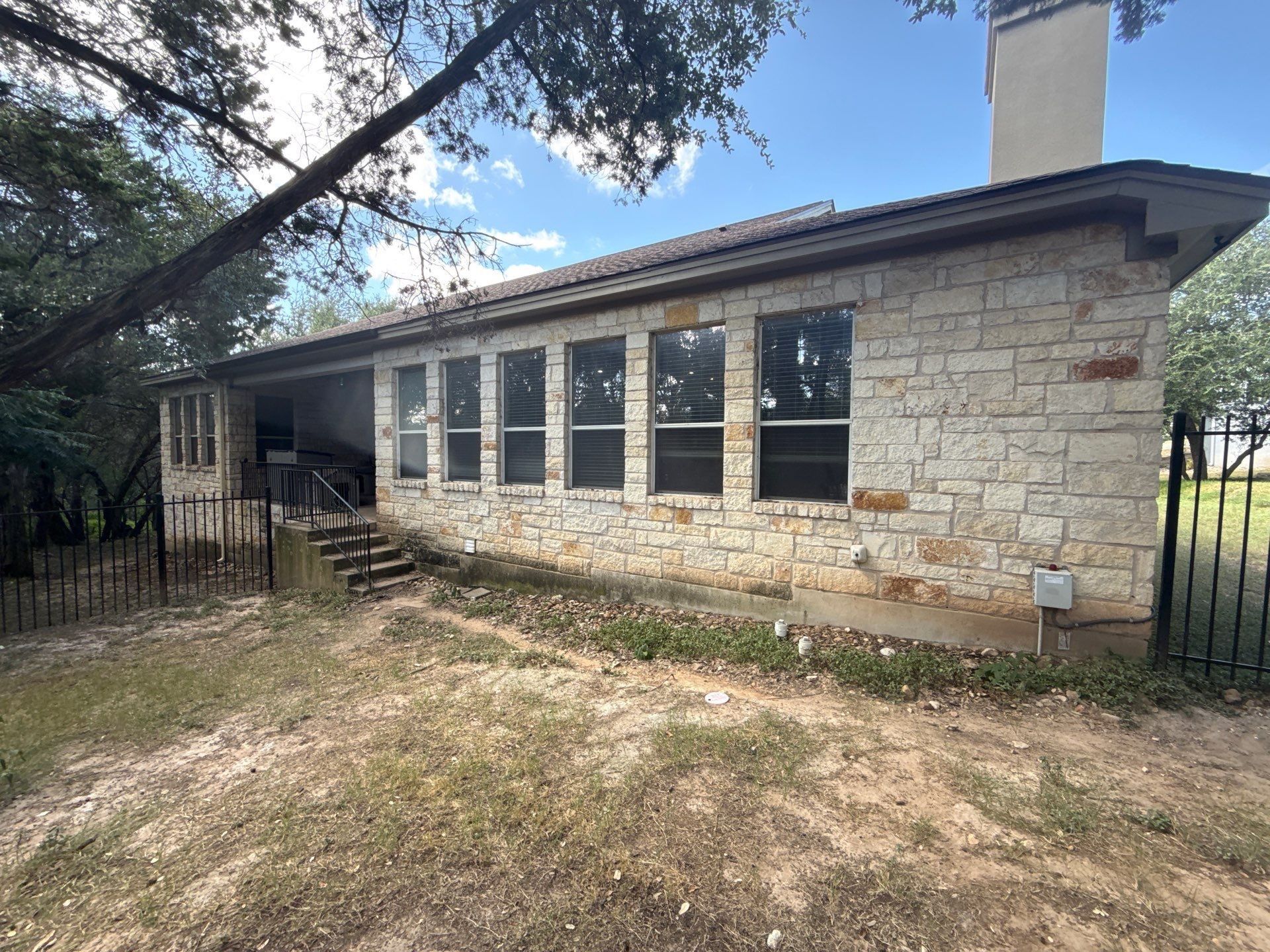 Side exterior with windows and chimney