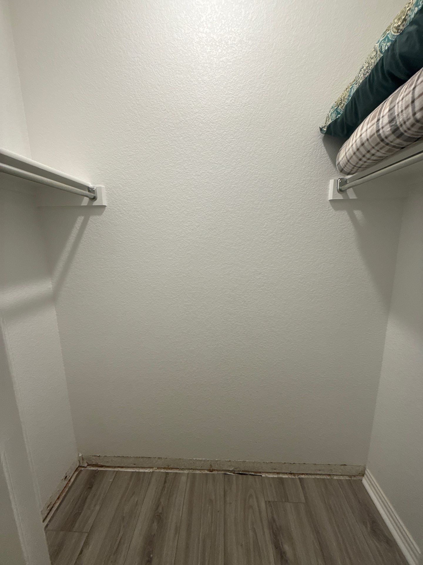 Bedroom closet with water-damaged baseboard