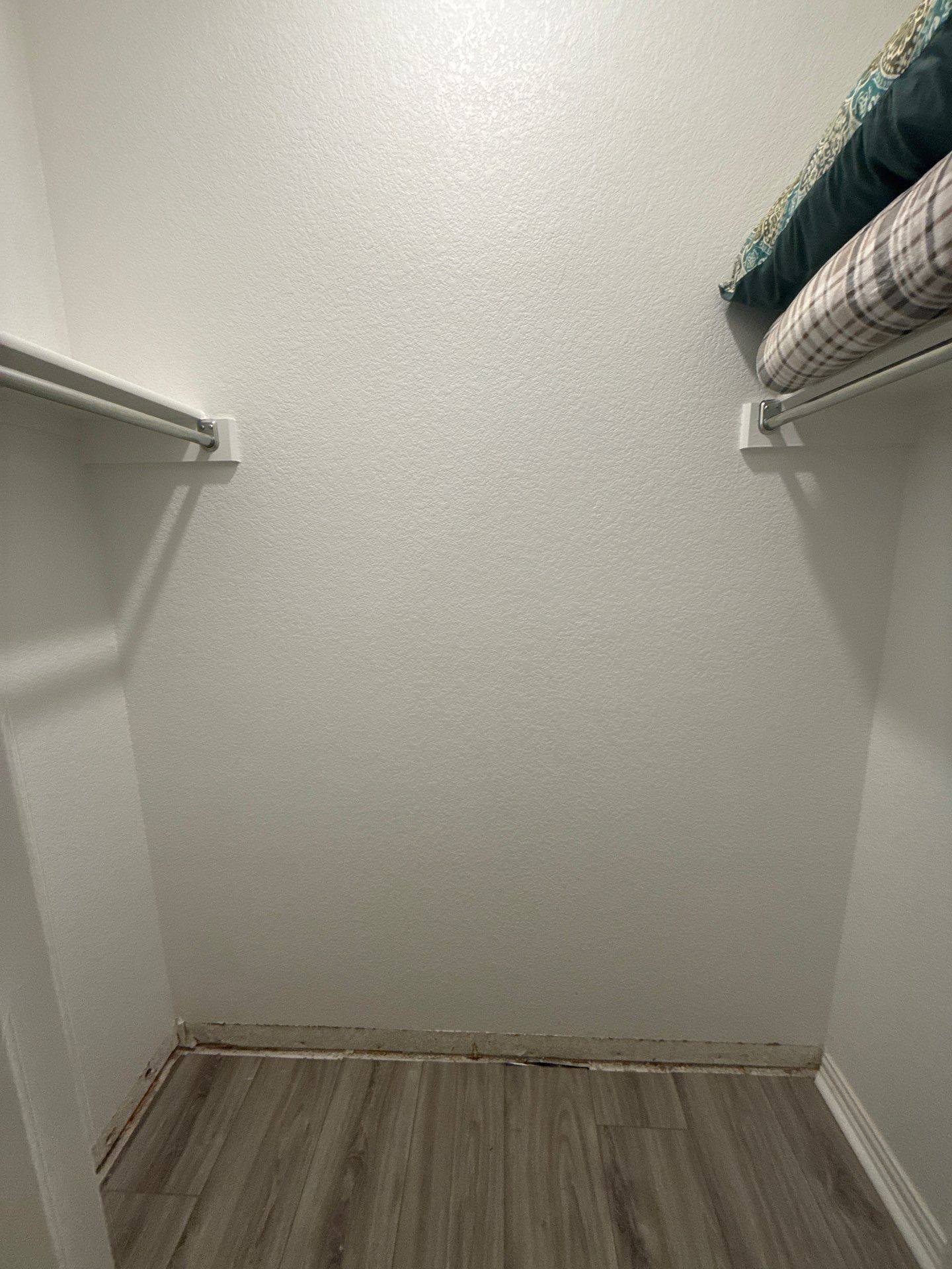 Bedroom closet with water-damaged baseboard