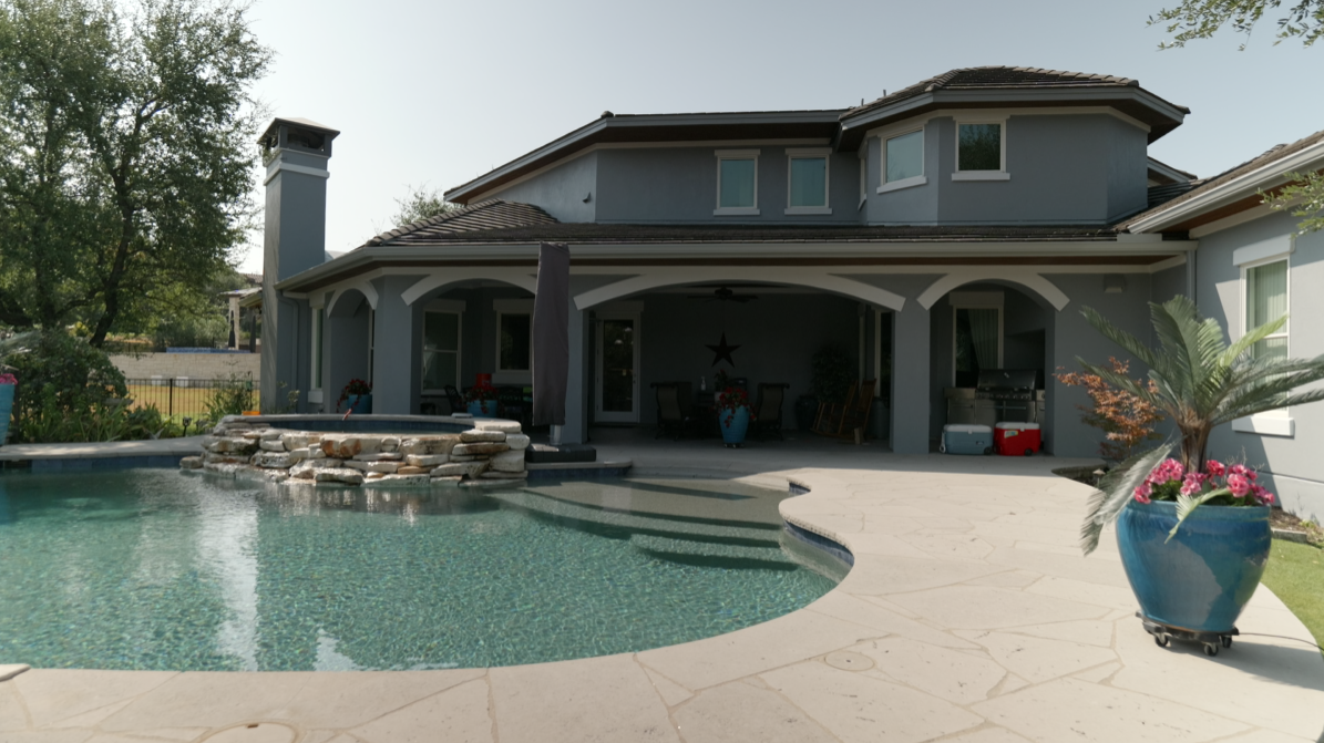 Pool and covered patio of the repainted Lakeway home