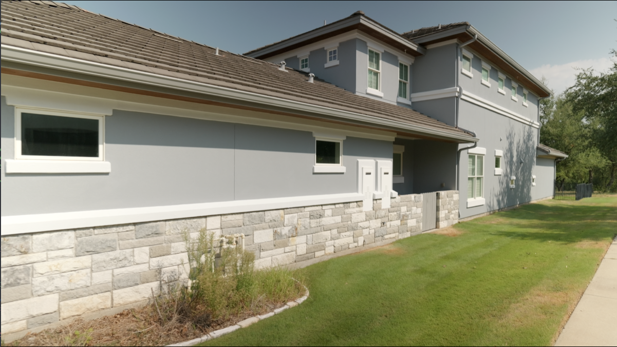 Stone wainscoting and side exterior wall of the Lakeway home