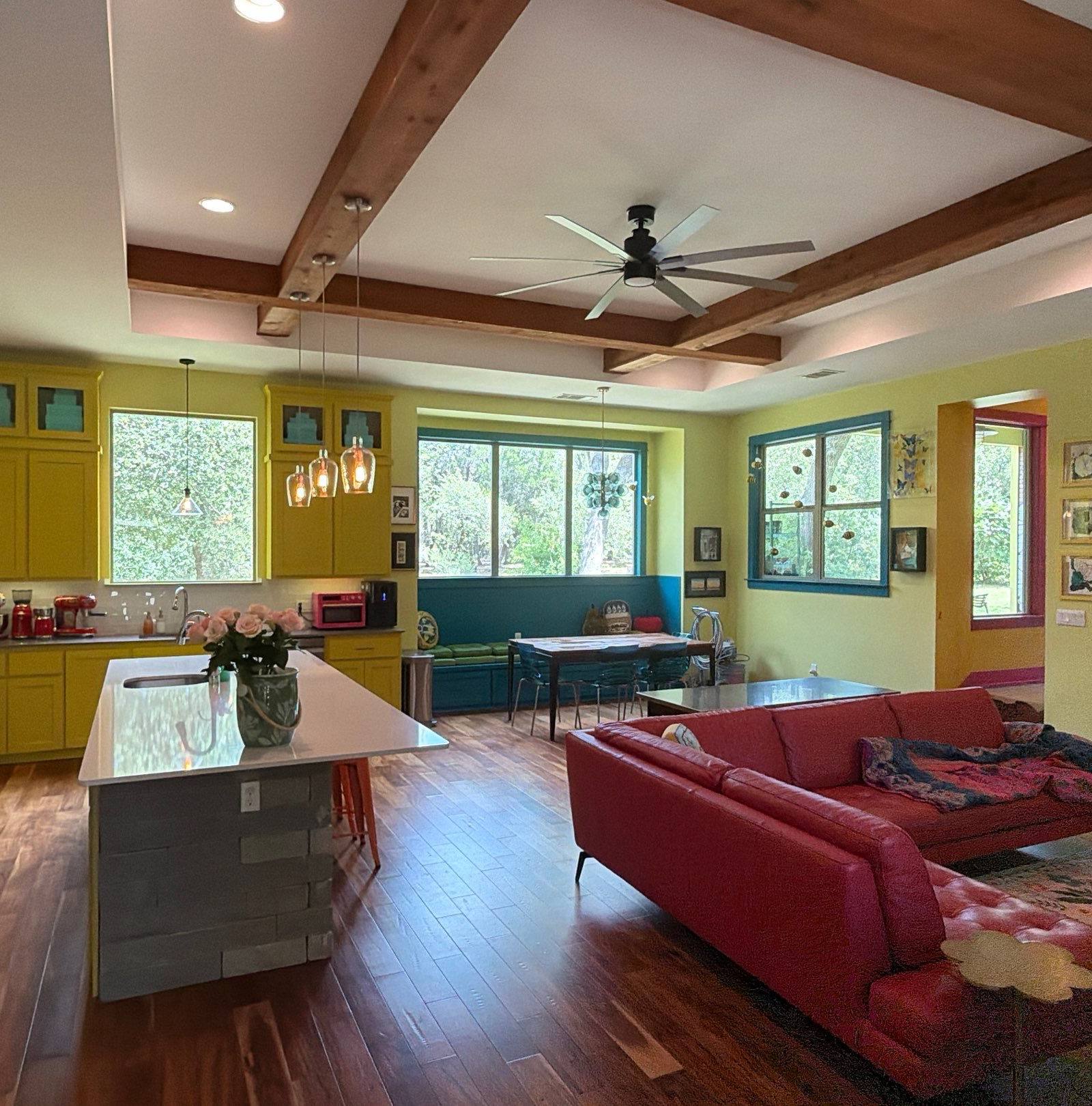 Colorful open-concept living room and kitchen in the repainted Bee Cave, Texas home